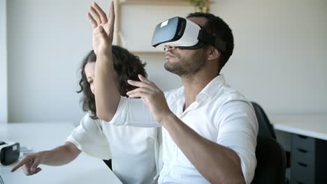 Slow-motion-of-cheerful-workers-testing-VR-headset